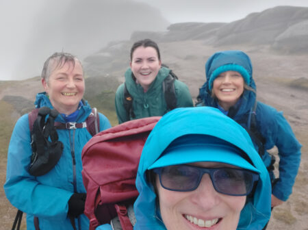 4 women on the summit of Slieve Binnian in poor weather.